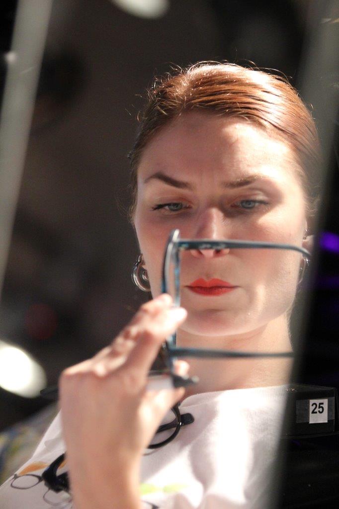 Woman trying on frames atRaise Your Glasses event
