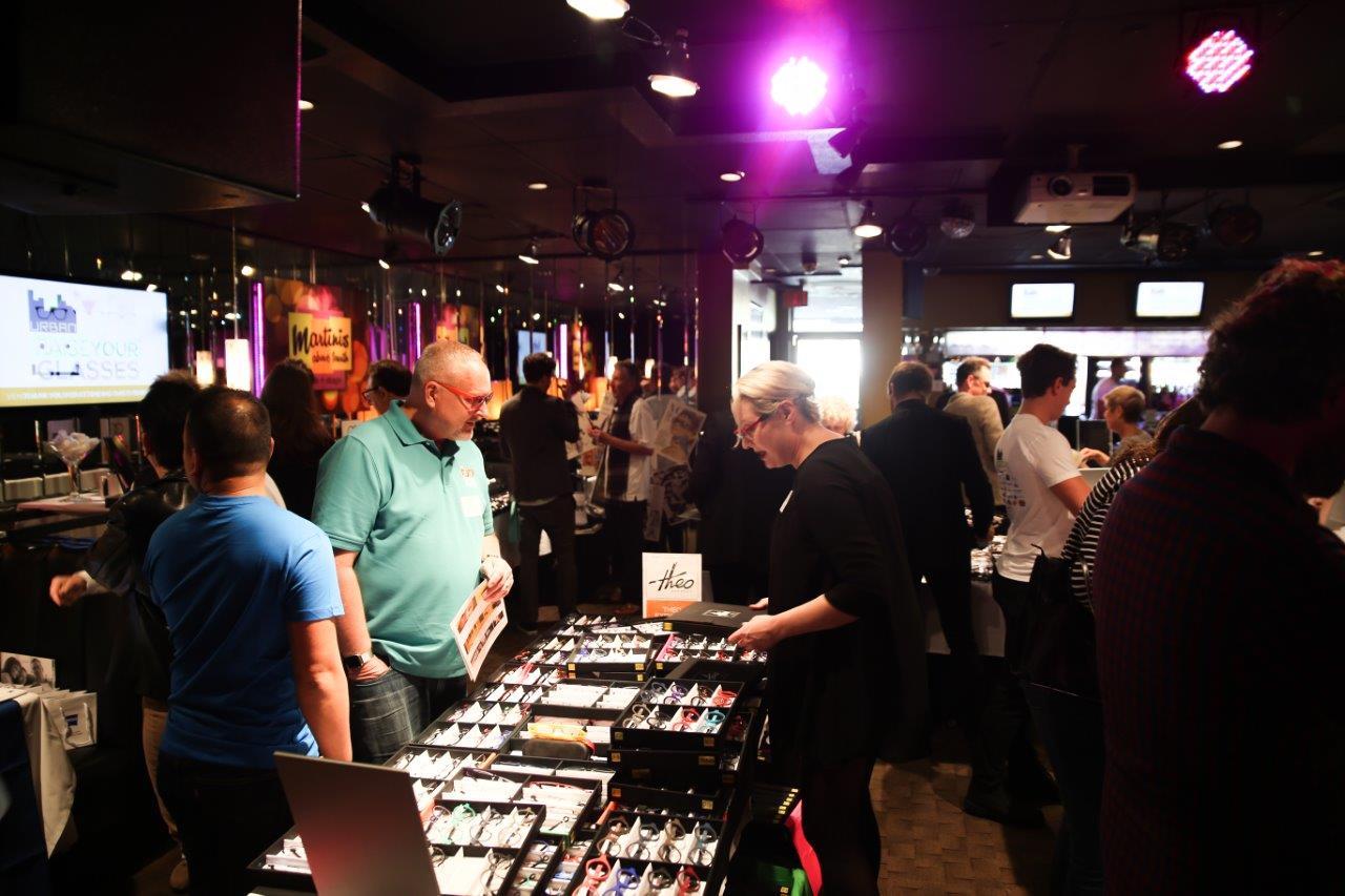 Many attendees standing inside Martinis Above Fourth at Raise Your Glasses event