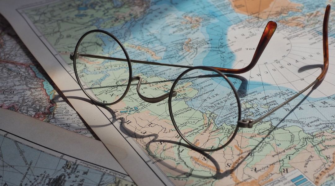Pair of metal frames sitting upsite down on a map of the world