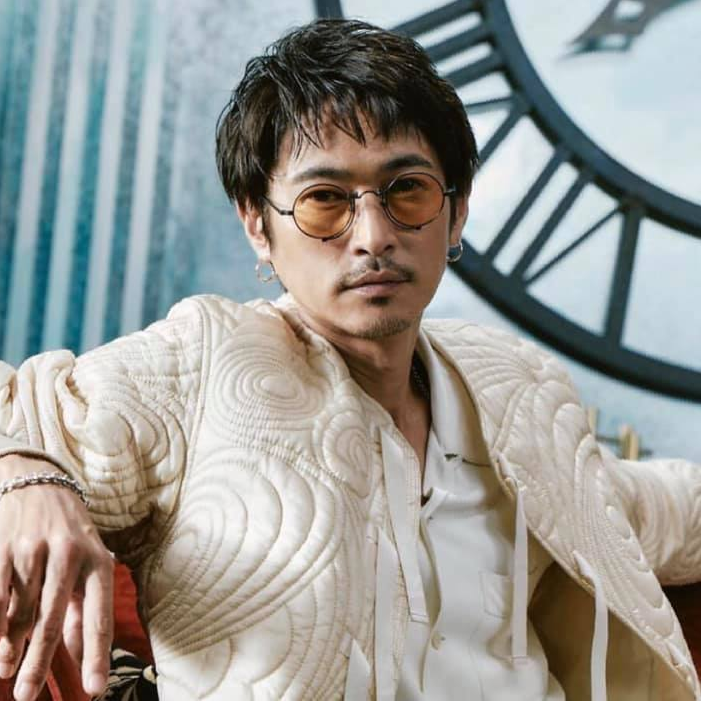 Man in jacket wearing Matsuda gold metal with gold mirror tint lenses sunglasses