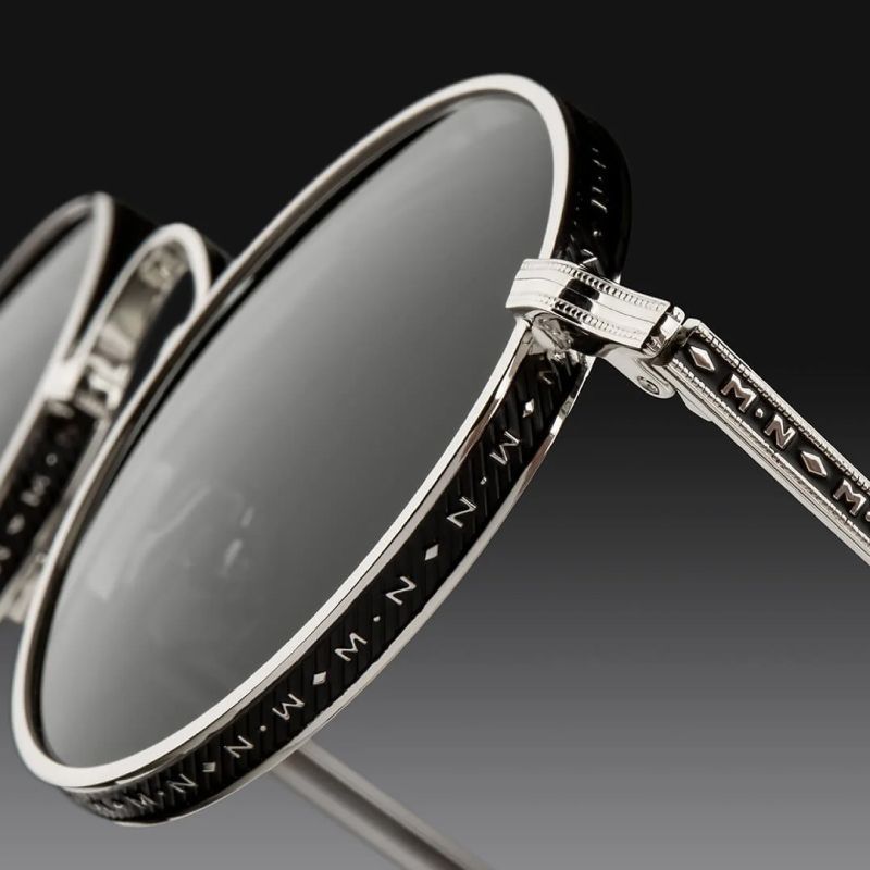 Closeup of the engraving detail on a silver and black Matsuda fram with the letter m on it