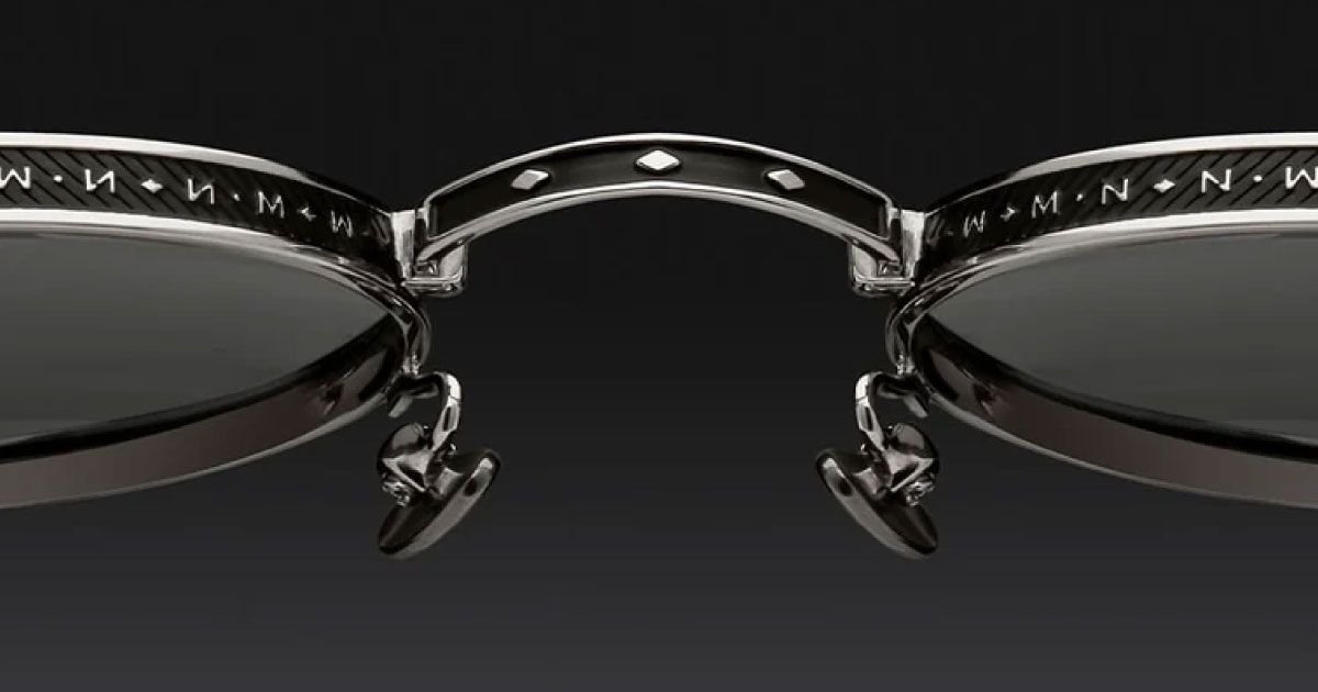 A close up of a pair of sunglasses on a black background.