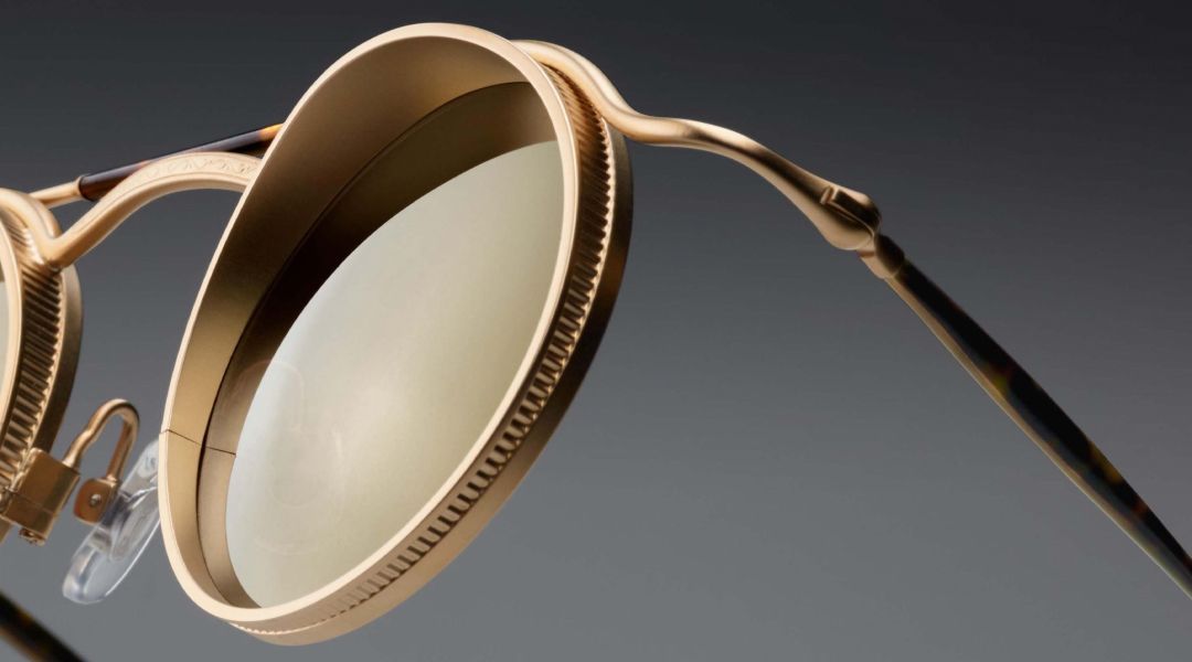 Close up of a pair of gold Matsuda sunglasses with gold lenses