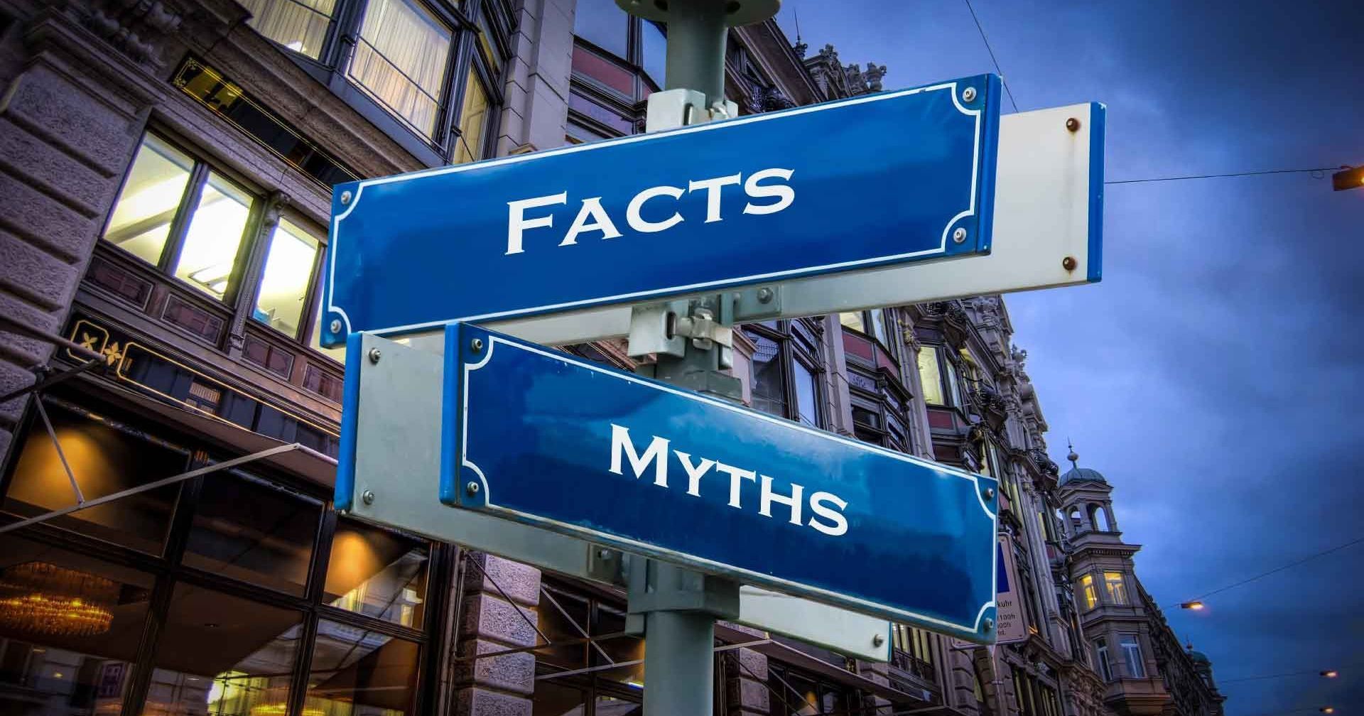 Blue street signs reading facts and myth