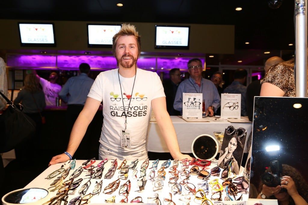 Vendor standing behind his table at 2015 Raise Your Glasses event