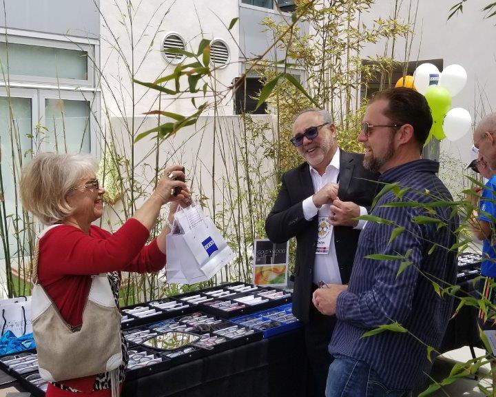 3 people smiling and chatting at 2019 Raise Your Glasses Event