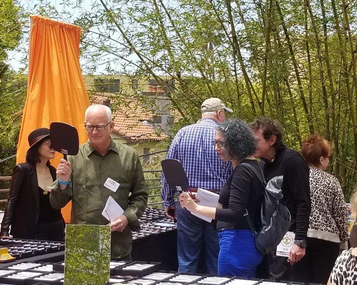 Shoppers looking in mirror while trying on glasses at 2019 Raise Your Glasses Event