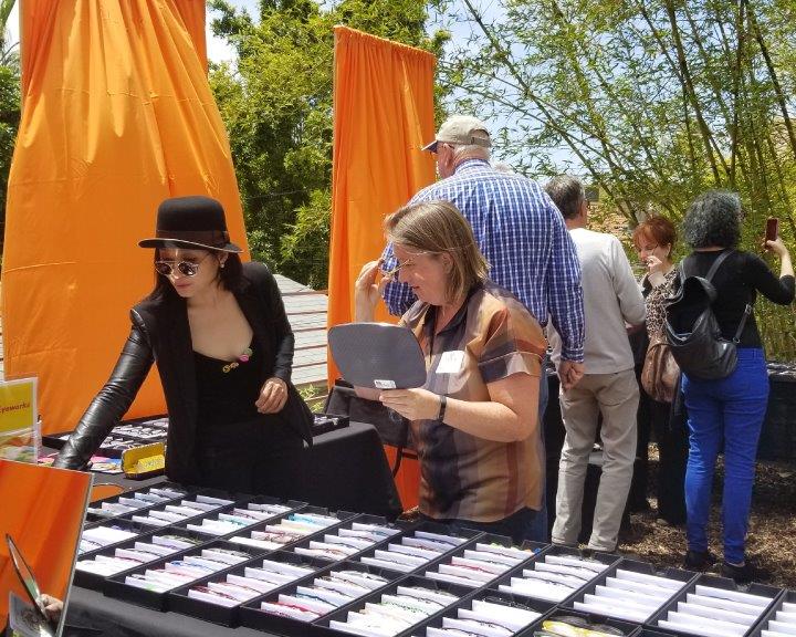 Shoppers trying on glasses at 2019 Raise Your Glasses Event