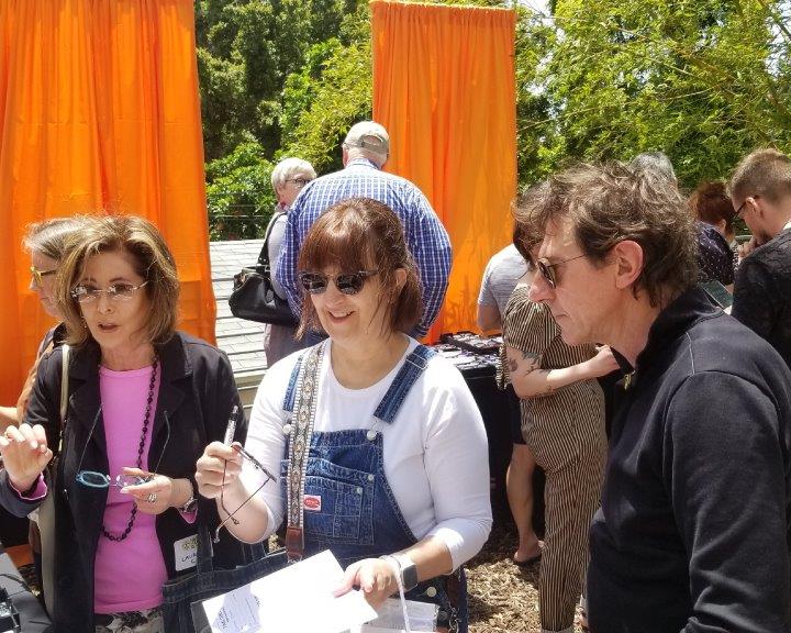 2 guests and vendor viewing sunglasses at 2019 Raise Your Glasses Event