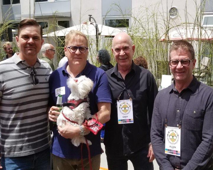 4 people and a dog posing for camera at Urban Optiks Optometry 2019 Raise Your Glasses Event