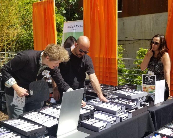 2 shoppers looking at frameline at Urban Optiks Optometry 2019 Raise Your Glasses Event