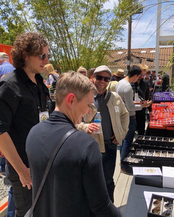Vendor and shopper viewing displays at Raise Your Glasses 2019 Event