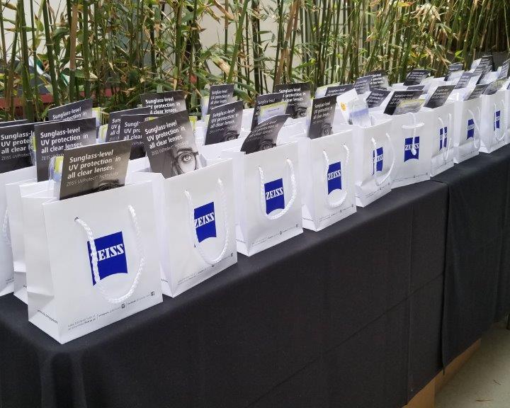 Small shopping bags with Zeiss logo on table at 2019 Raise Your Glasses Event