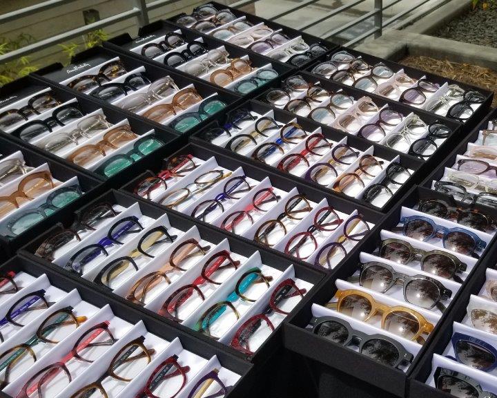 Many colorful eyeglass frames in display boxes at 2019 Raise Your Glasses Event