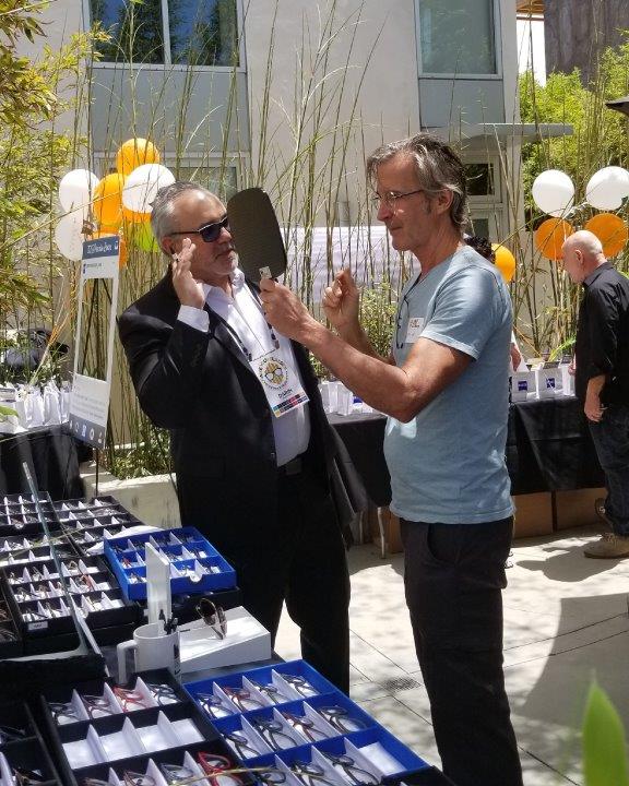 Person trying on eyeglass frames at Raise Your Glasses 2019 Event