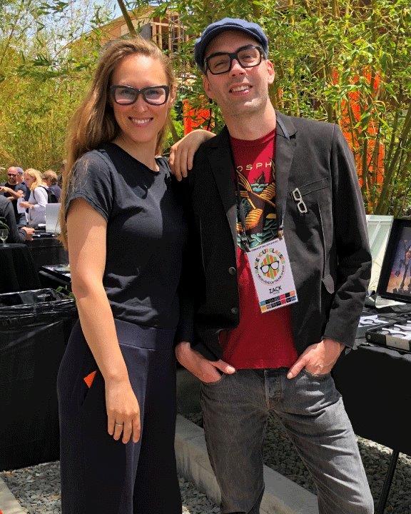 Two people wearing glasses and smiling at Raise Your Glasses 2019 Event