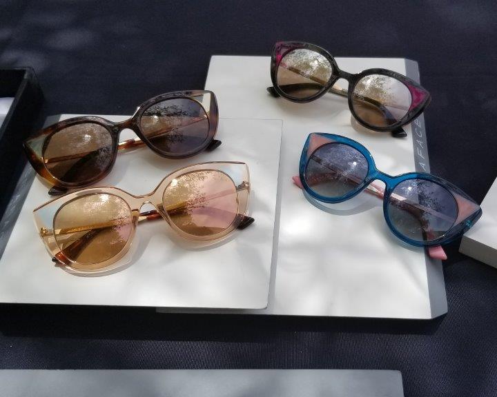 4 sunglass frames displayed on white tabletop at 2019 Raise Your Glasses Event