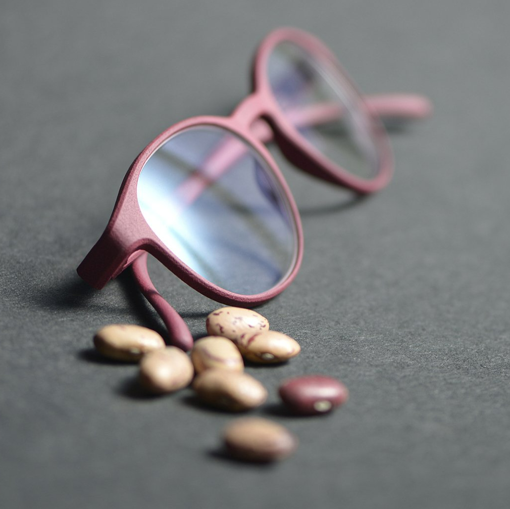 Burgundy frame displayed with caster beans