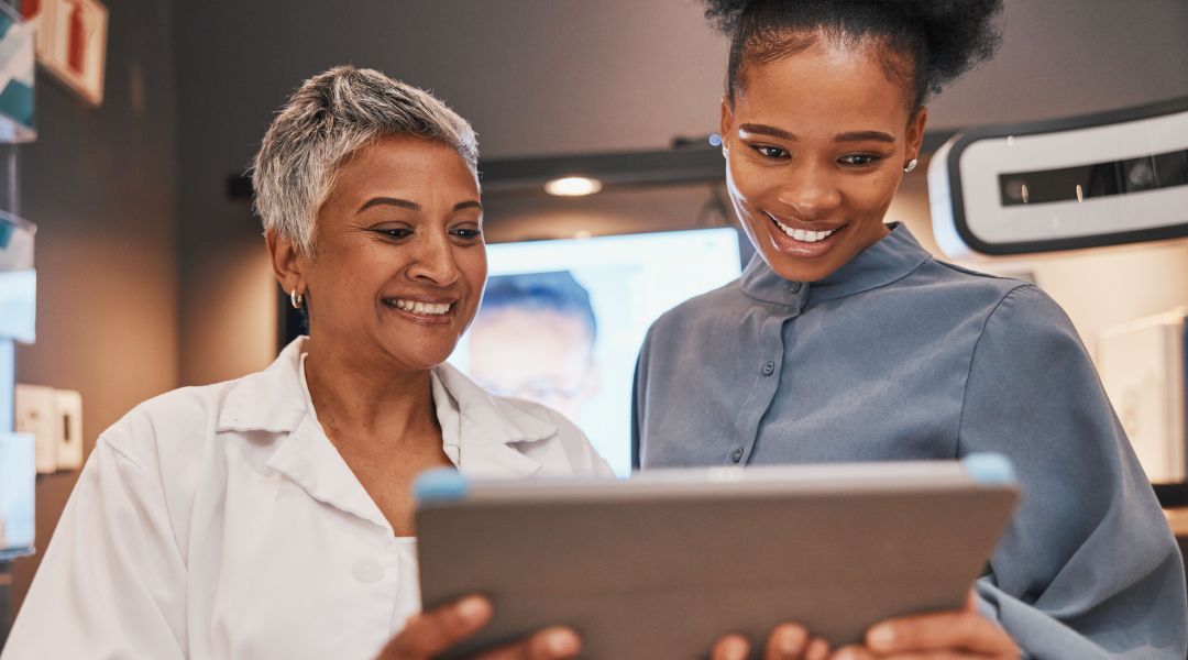 An optometrist with a patient viewing the screen of an iPad