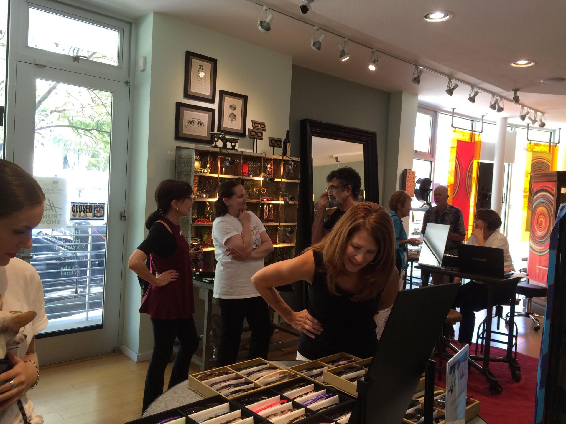 People talking to vendor at 2016 Theo Trunk Show Event