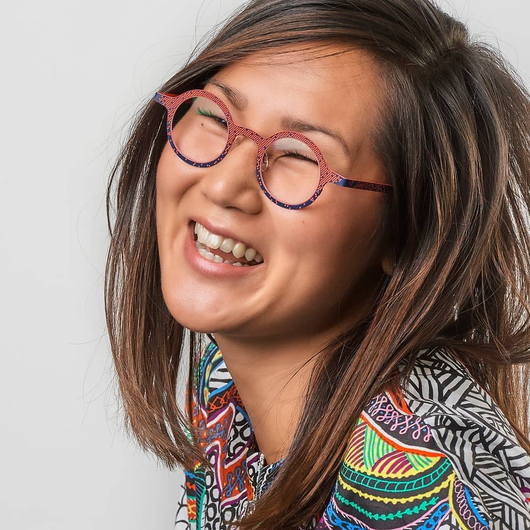 Young woman in red and purple round eyeglass frames