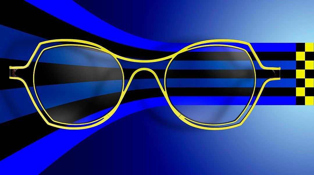 Pair of Theo yellow metal frames on a blue and black futuristic background