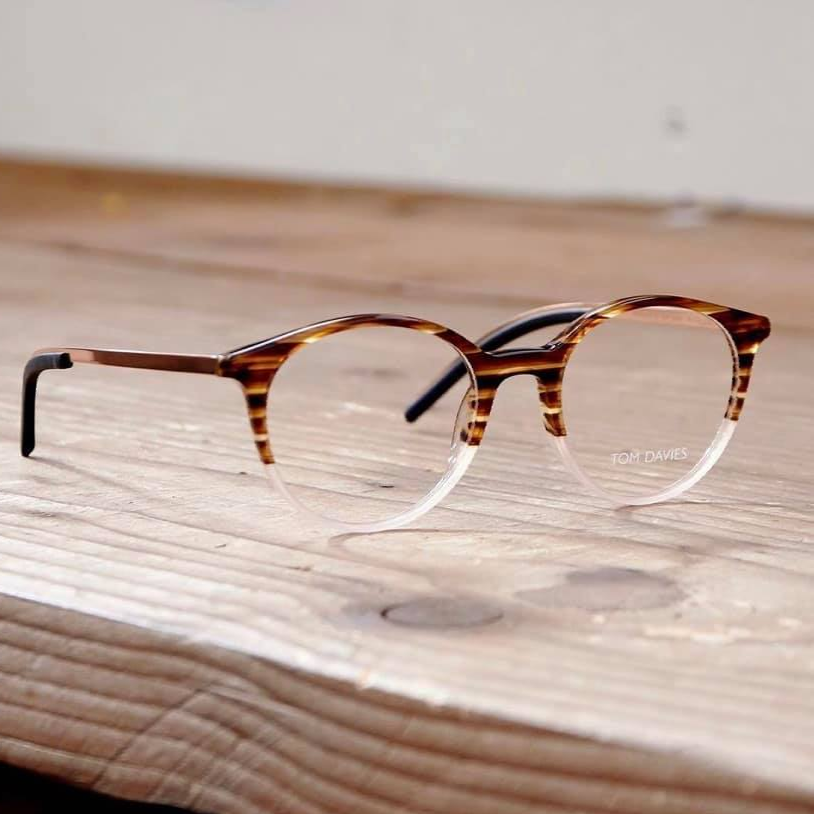 Tom Davies Eyewear frame on wooden table