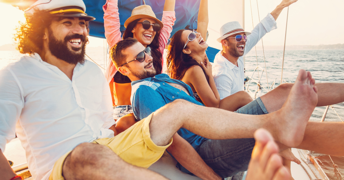 a group of people wearing sunglasses enjoying the outdoors on a sailboat