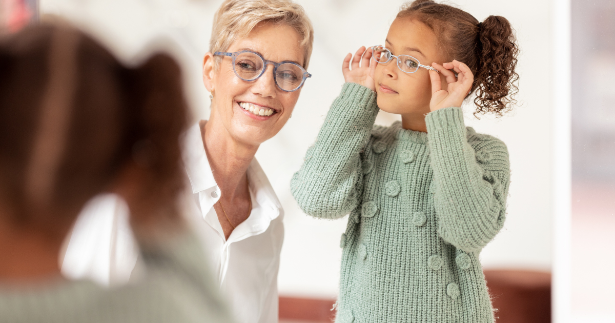 Young person wearing glasses and person wearing glasses looking in mirror