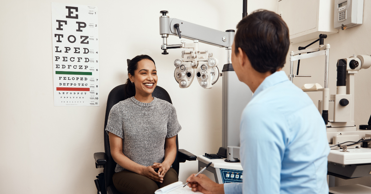 Eyecare professional and patient in office with eye chart and equipment