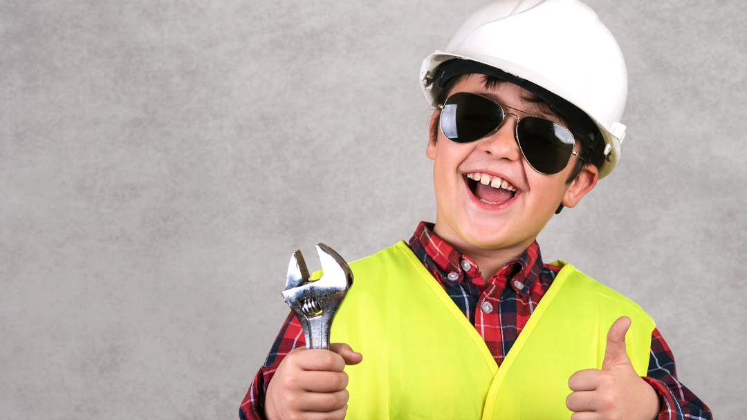 Child wearing safety helmet, safety vest and glasses