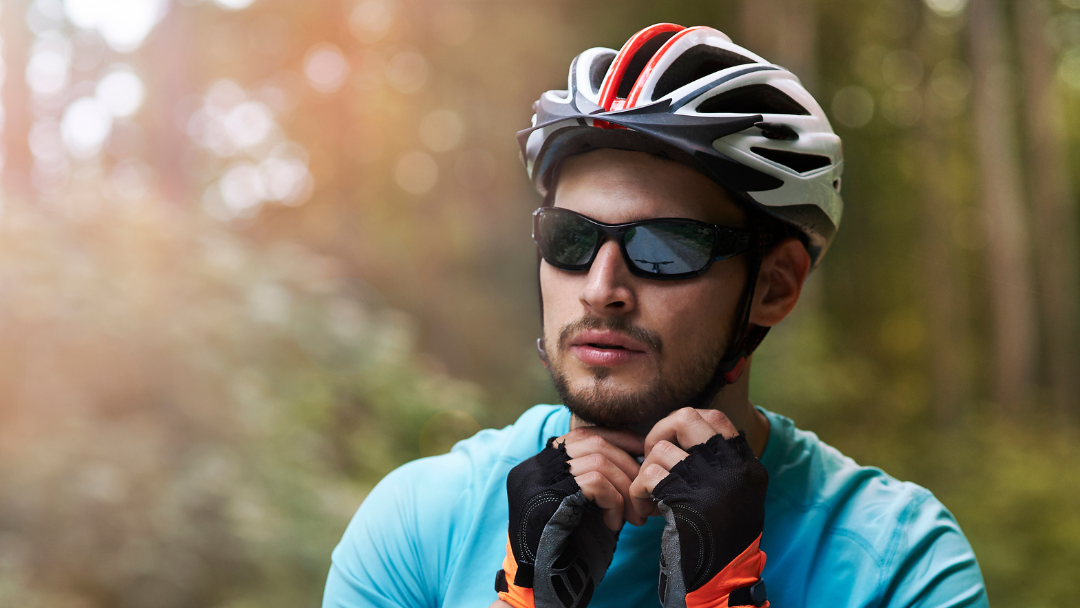 Person wearing helmet, protective eyewear and gloves