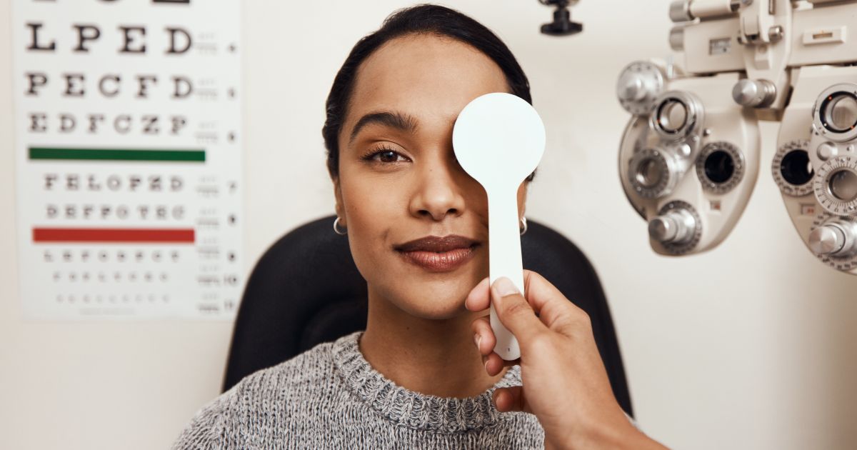 A woman getting her eyes checked by an optometrist