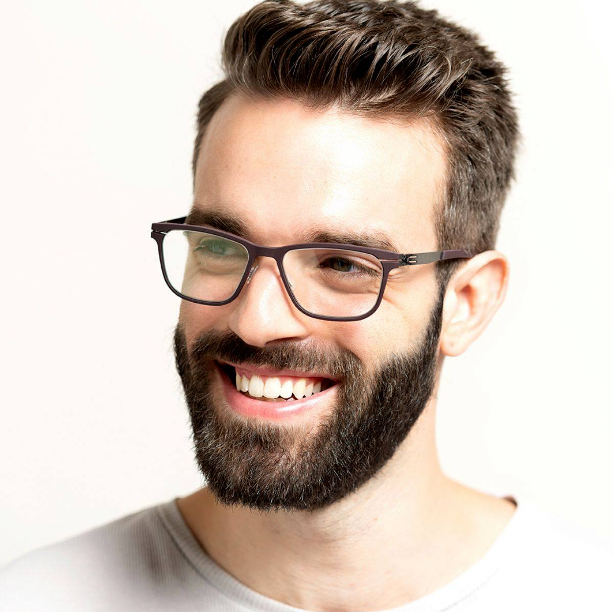 Man with a beard wearing a brown metal ic! ierlin frame