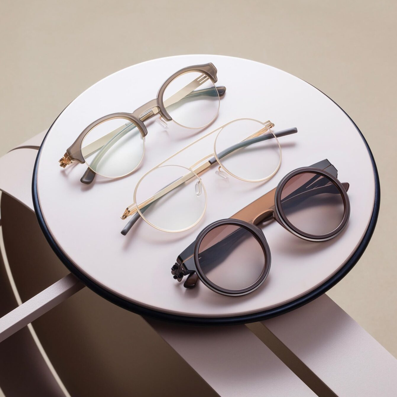 Two ic! berlin frames in white and silver metal with one black ic! Berlin sunglass in black