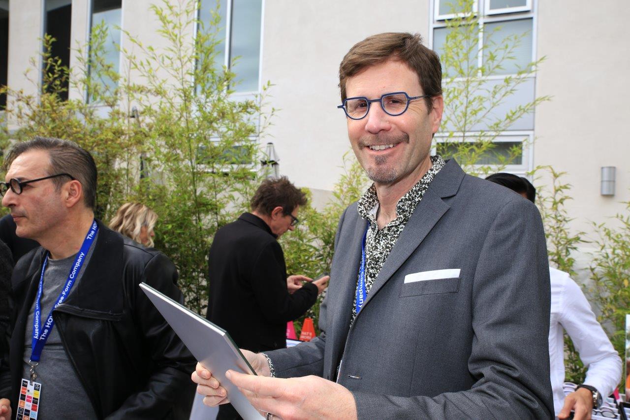 Person trying on glasses at Raise Your Glasses 2017 Event