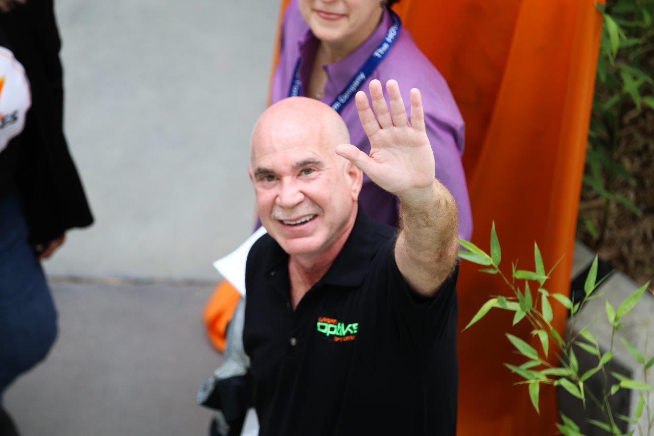 View from above of Dr Klein waving at Raise Your Glasses 2017 Event