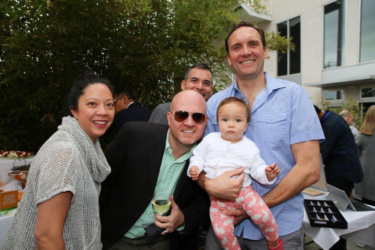 Group of people smiling at camera at Raise Your Glasses 2017 Event