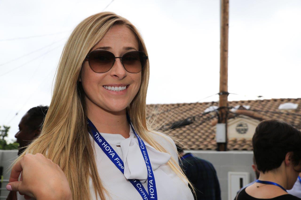 Smiling woman wearing sunglasses at Raise Your Glasses 2017 event