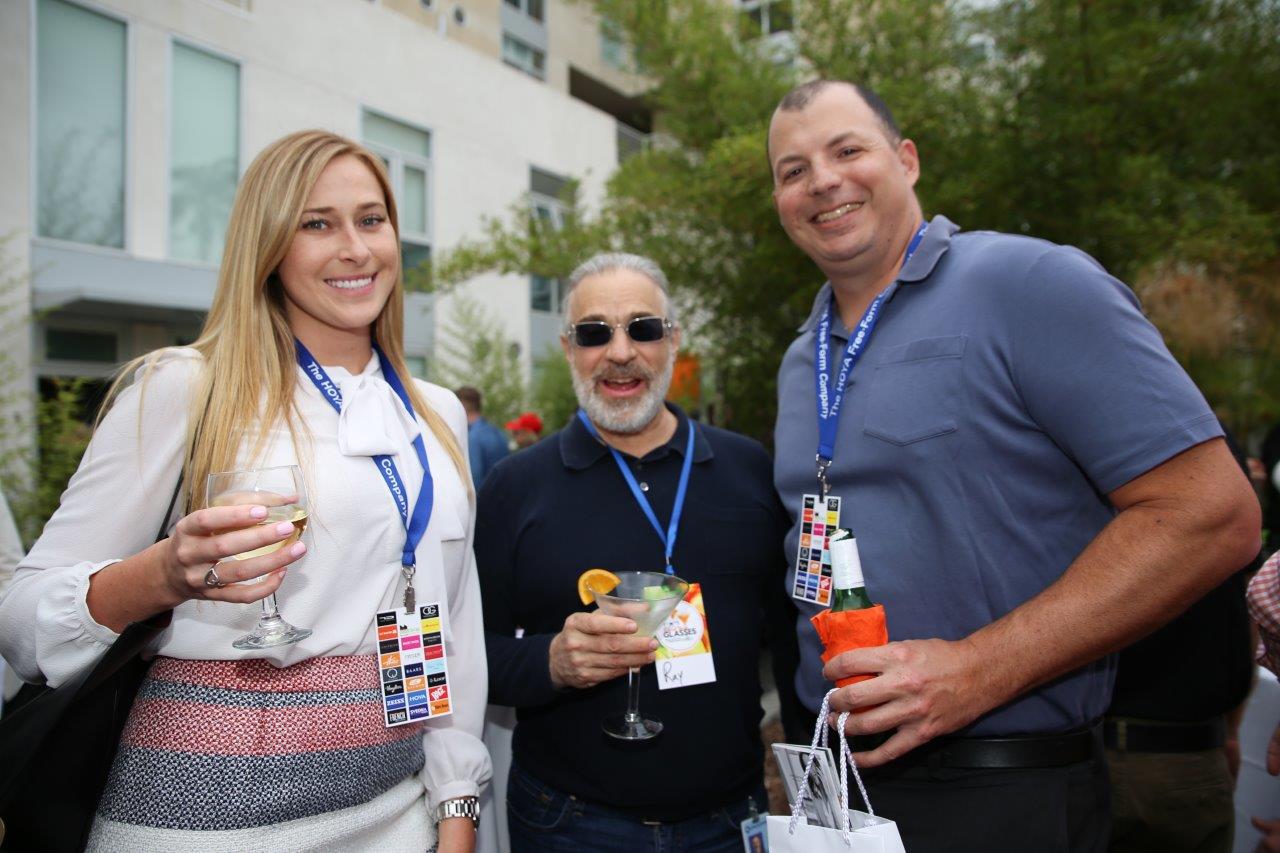 3 people holding drinks and posing at Raise Your Glasses 2017 Event