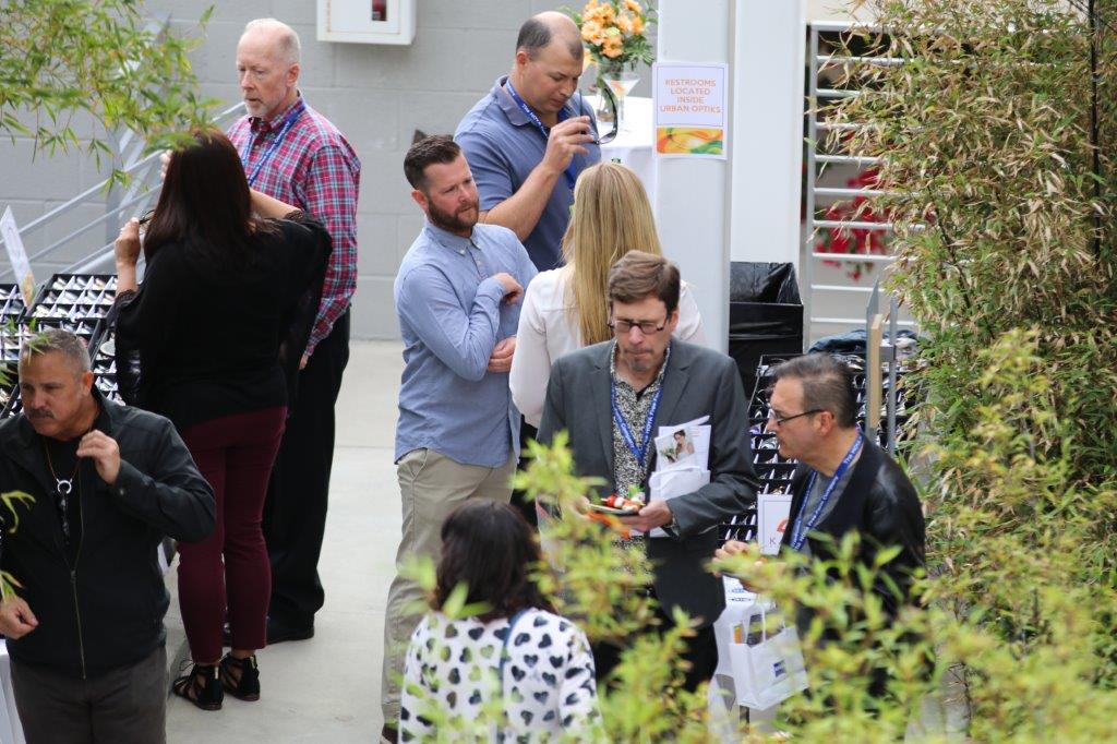 People talking in small groups at Raise Your Glasses 2017 Event