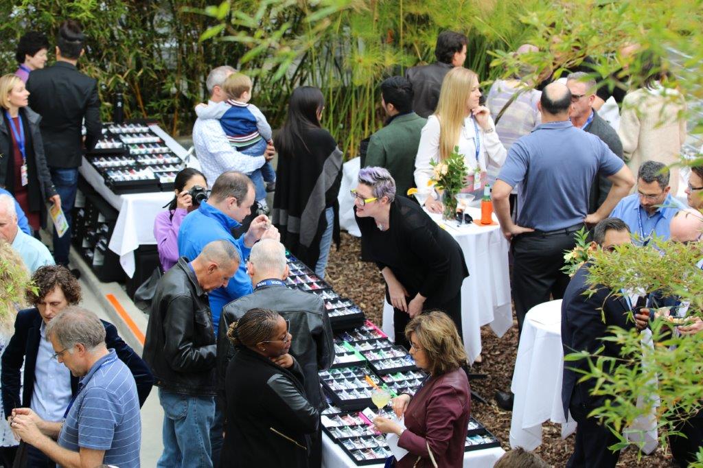 Vendor and guests at outside display table at Raise Your Glasses 2017 Event
