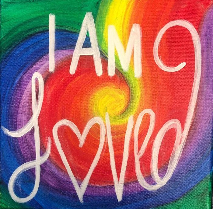 Colorful painting with rainbow swirls and the words “I AM Love” in white script with a heart shape.