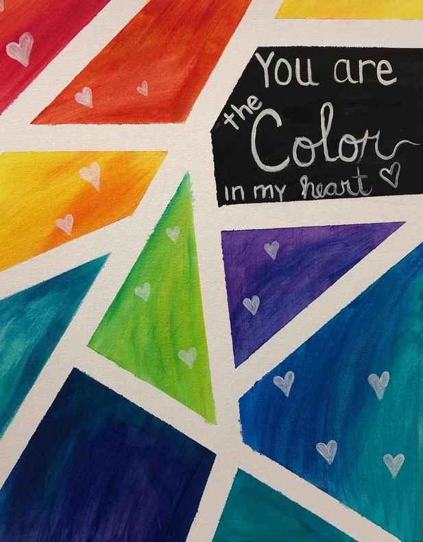 Colorful geometric mural with a black sign reading “You are the Color in my heart”