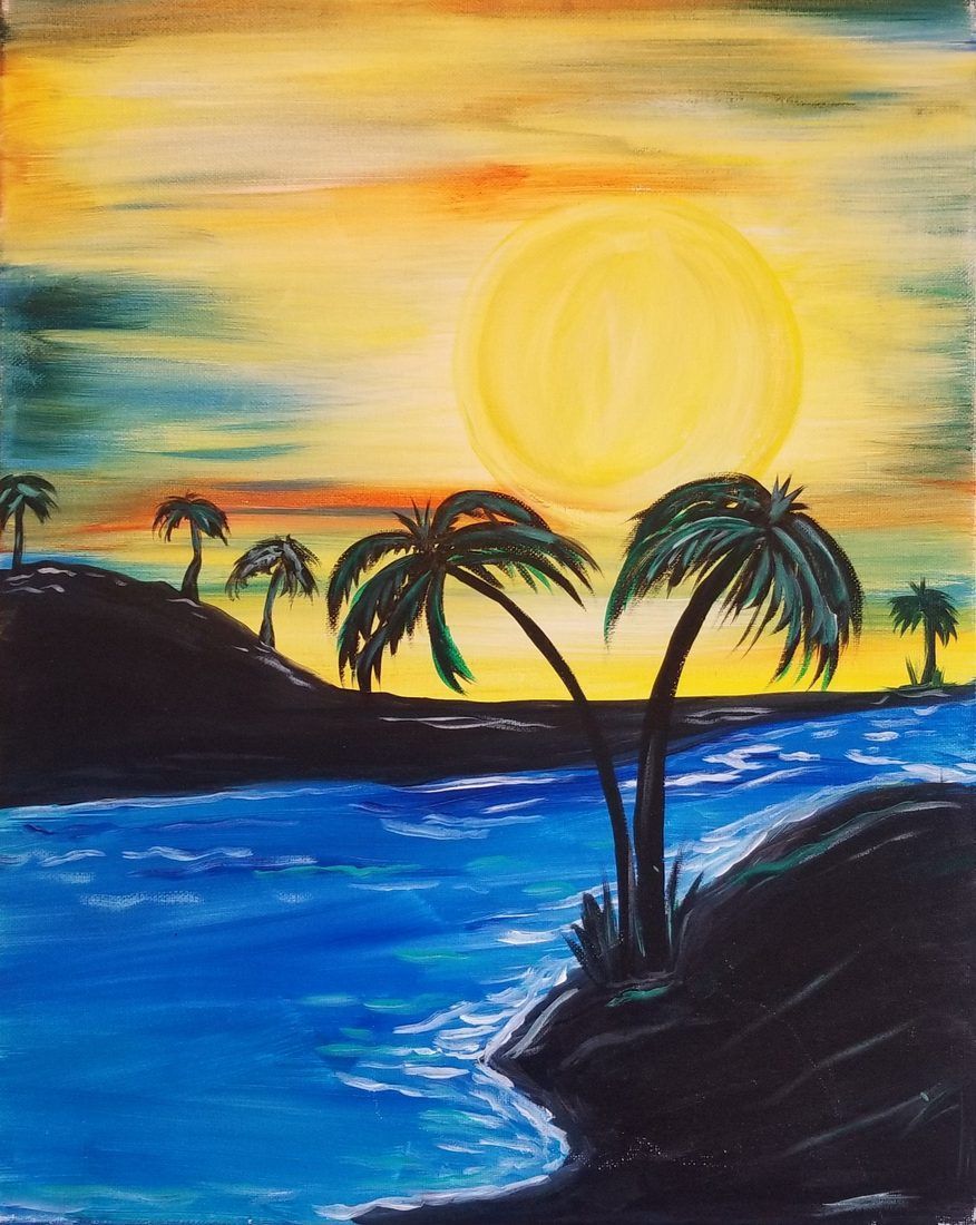 Tropical sunset over blue water with silhouetted palm trees and dark rocky shores