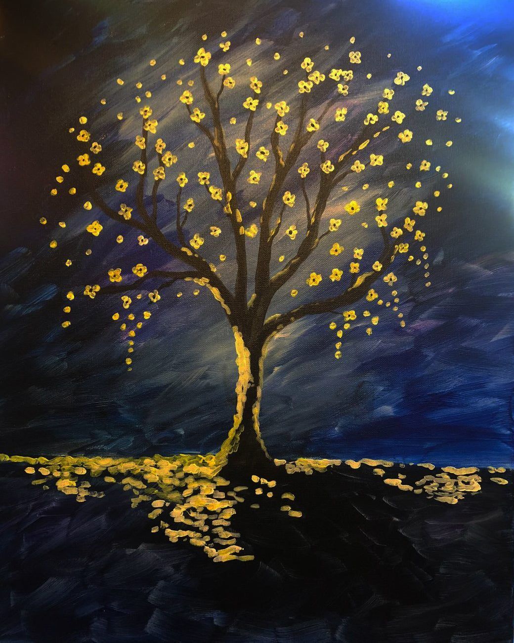 Golden-leaved tree glowing against a dark blue night sky, with yellow leaves scattered at its base.