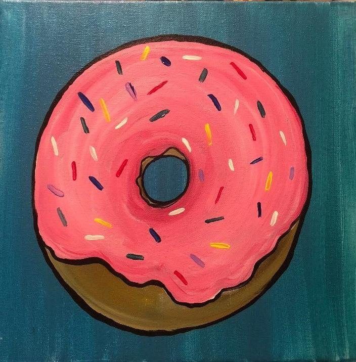 Pink frosted donut with colorful sprinkles on a teal background