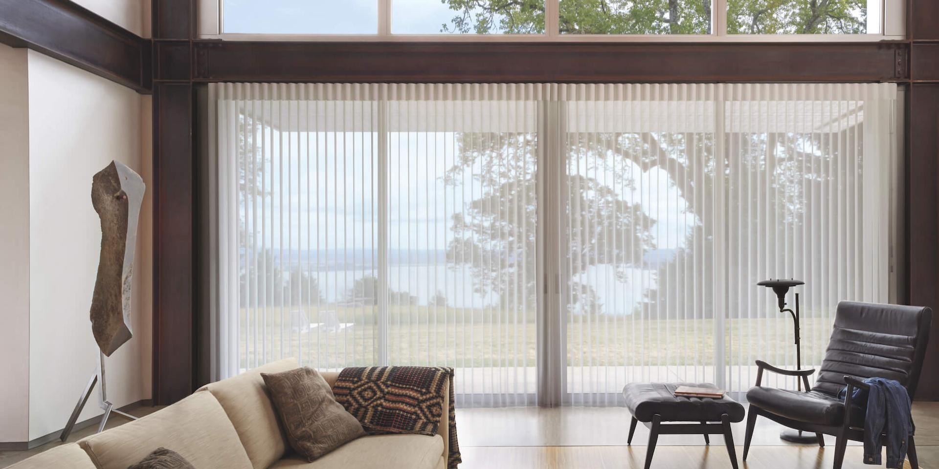 Hunter Douglas vertical sheer shades as a large window treatment in a chic living room