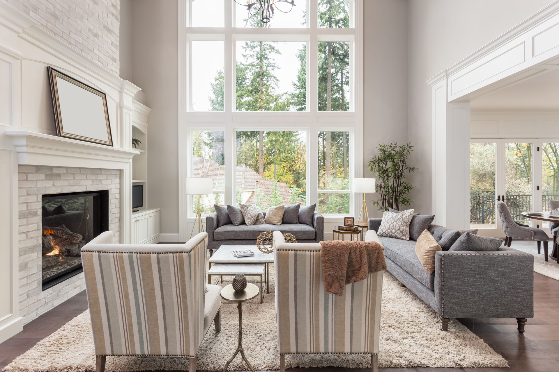 Windows in a living room that are in need of custom window treatments for light control 