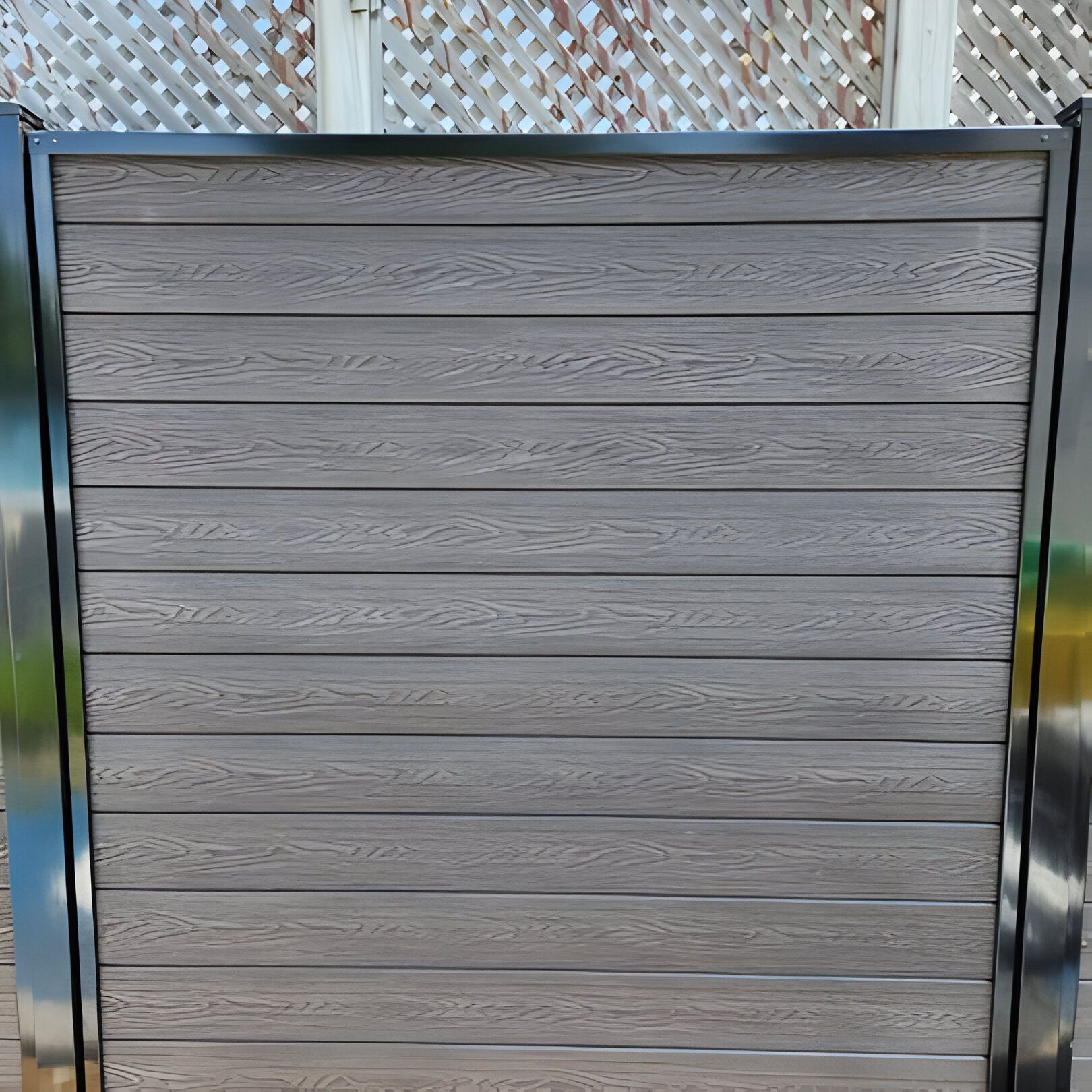 Gray wooden plank fence with black metal frame.